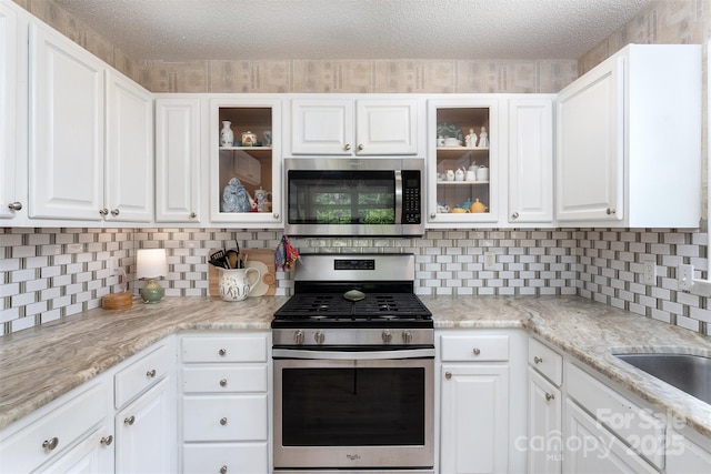 330 Stonehollow Rd, Fletcher, NC 28732 - kitchen featuring stainless steel appliances, white cabinets, tasteful backsplash, and a textured ceiling