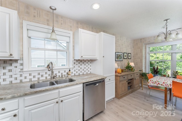 330 Stonehollow Rd, Fletcher, NC 28732 - kitchen with stainless steel dishwasher, white cabinetry, tasteful backsplash, light wood-style flooring, and wallpapered walls