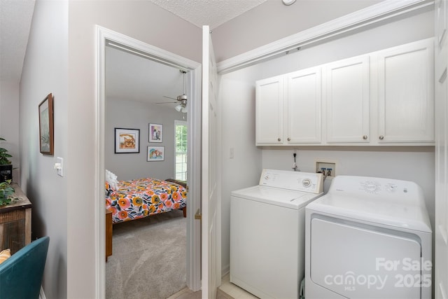 330 Stonehollow Rd, Fletcher, NC 28732 - laundry area featuring washing machine and dryer, cabinet space, ceiling fan, light colored carpet, and a textured ceiling