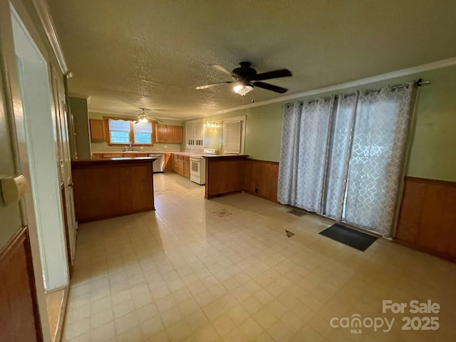 2411 Rebecca Ave, Charlotte, NC 28208 - kitchen featuring white electric range, ornamental molding, ceiling fan, a peninsula, and wainscoting