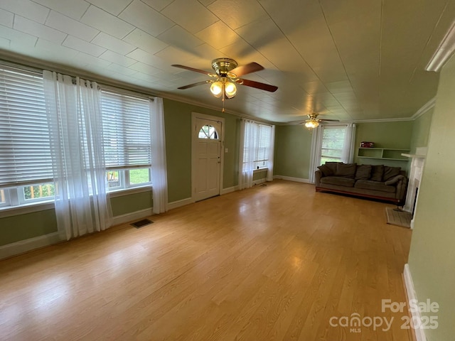 2411 Rebecca Ave, Charlotte, NC 28208 - foyer with a ceiling fan, ornamental molding, and light wood-style floors