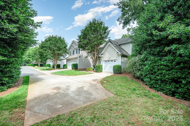 4703 David Cox Rd, Charlotte, NC 28269 - obstructed view of property with concrete driveway, a garage, and a front lawn