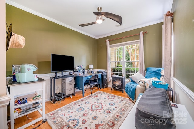 4703 David Cox Rd, Charlotte, NC 28269 - office with wood finished floors, ornamental molding, ceiling fan, and a wood stove