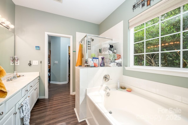 4703 David Cox Rd, Charlotte, NC 28269 - full bath featuring plenty of natural light, a garden tub, wood finished floors, and a shower stall