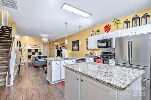 460 Clouds Way, Rock Hill, SC 29732 - kitchen with black appliances, a peninsula, dark wood-style floors, a kitchen island, and white cabinetry