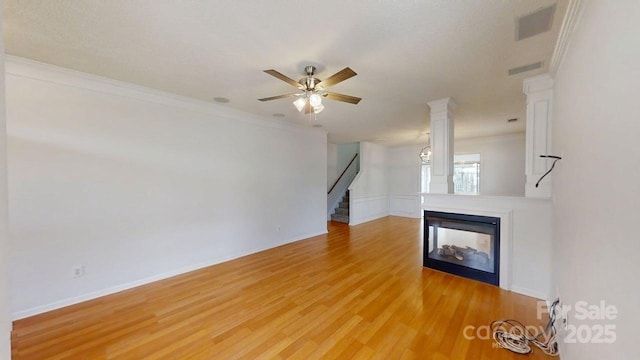 15280 Leslie Brook Rd, Huntersville, NC 28078 - unfurnished living room featuring a multi sided fireplace, stairway, light wood-style floors, crown molding, and ceiling fan