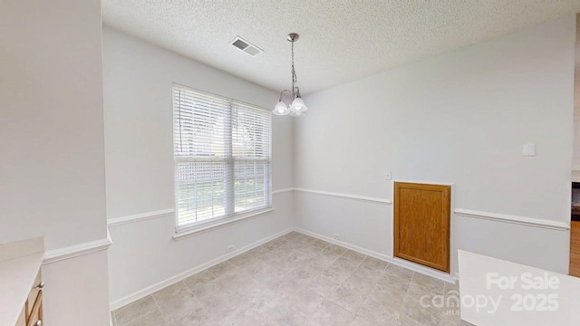15280 Leslie Brook Rd, Huntersville, NC 28078 - spare room with healthy amount of natural light, a chandelier, and a textured ceiling