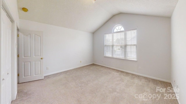 15280 Leslie Brook Rd, Huntersville, NC 28078 - empty room with carpet floors, lofted ceiling, a smoke detector, and a textured ceiling