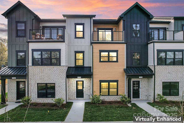 732 Falling Oak Aly Unit 22, Huntersville, NC 28078 - view of front of house featuring board and batten siding, a balcony, a standing seam roof, and brick siding