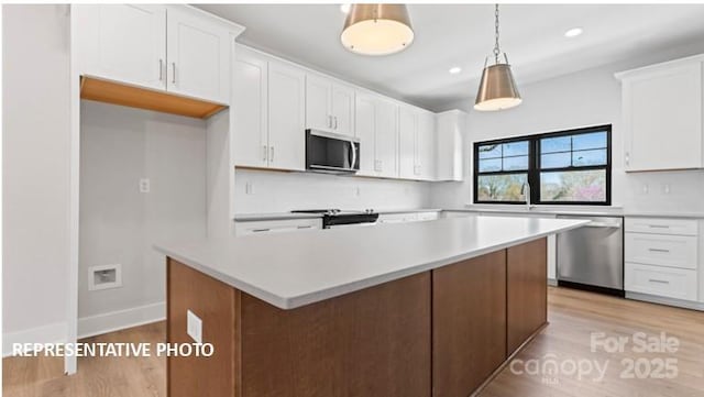 732 Falling Oak Aly Unit 22, Huntersville, NC 28078 - kitchen featuring stainless steel appliances, white cabinetry, light wood finished floors, light countertops, and recessed lighting