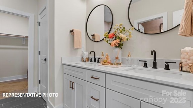 732 Falling Oak Aly Unit 22, Huntersville, NC 28078 - bathroom featuring double vanity, a walk in closet, and tile patterned flooring