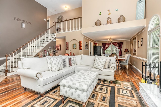2133 Highland View Ln, Charlotte, NC 28214 - living room featuring a chandelier, wood finished floors, a towering ceiling, and stairway