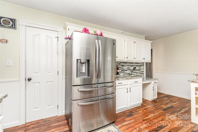 2133 Highland View Ln, Charlotte, NC 28214 - kitchen featuring stainless steel refrigerator with ice dispenser, wainscoting, dark wood-style floors, white cabinetry, and tasteful backsplash