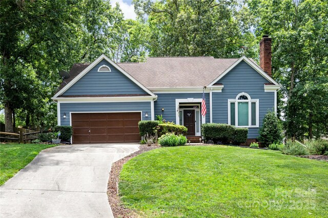 2133 Highland View Ln, Charlotte, NC 28214 - view of front of home featuring driveway, an attached garage, and a chimney