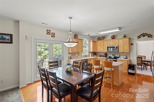 4966 Riverview Dr, Harrisburg, NC 28075 - dining room with light wood-style flooring and baseboards