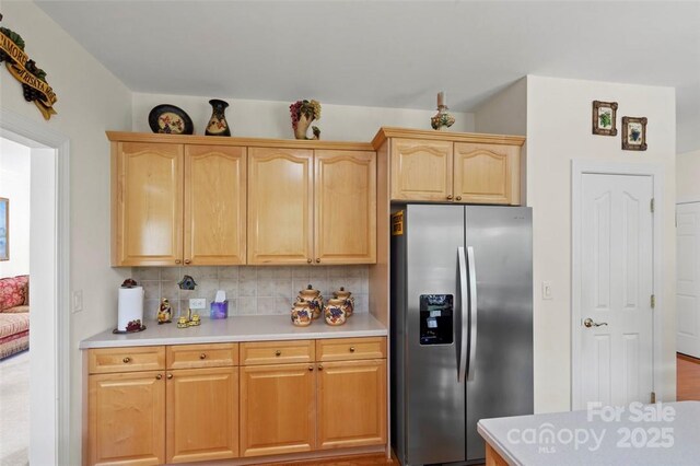 4966 Riverview Dr, Harrisburg, NC 28075 - kitchen with stainless steel fridge, light brown cabinetry, decorative backsplash, and light countertops