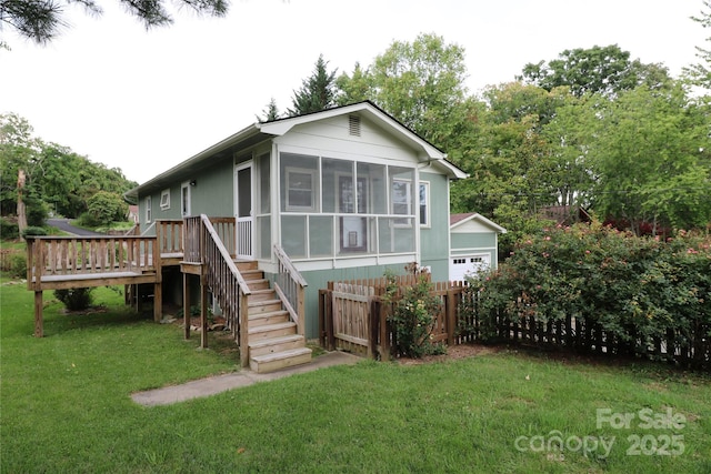 9 Oakland St, Weaverville, NC 28787 - view of front facade featuring a sunroom, stairway, and a deck