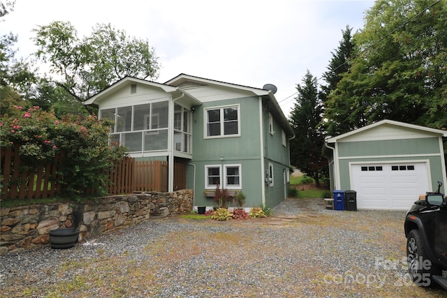 9 Oakland St, Weaverville, NC 28787 - view of front facade featuring a sunroom, driveway, and an outdoor structure