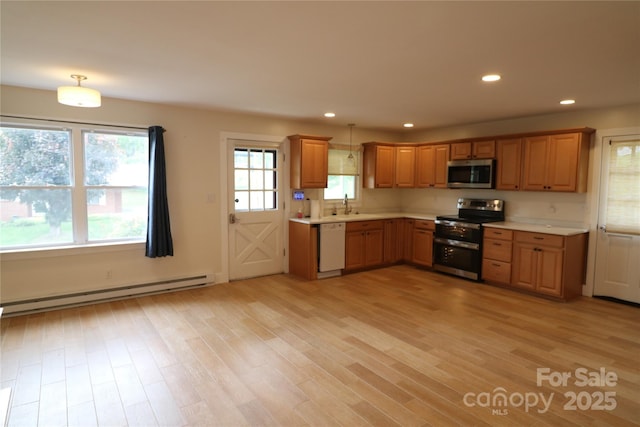 9 Oakland St, Weaverville, NC 28787 - kitchen featuring stainless steel appliances, a baseboard radiator, light countertops, light wood finished floors, and recessed lighting