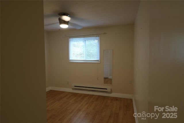 9 Oakland St, Weaverville, NC 28787 - unfurnished room featuring baseboard heating, wood finished floors, and ceiling fan