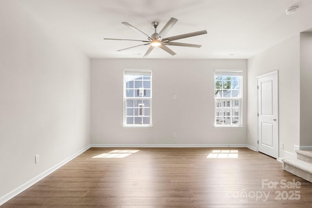 1204 May Apple Dr, Matthews, NC 28104 - spare room with wood finished floors, ceiling fan, stairs, and a smoke detector
