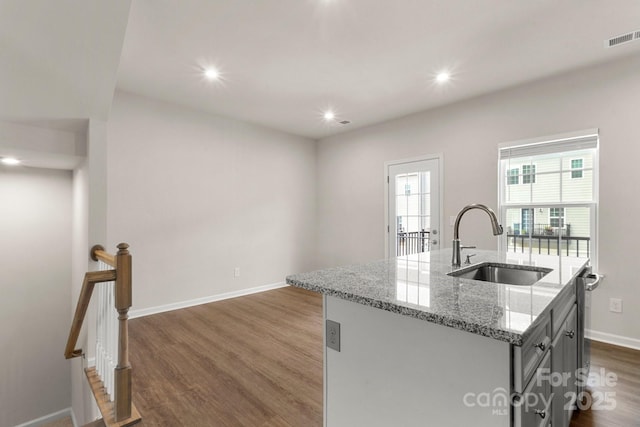 1204 May Apple Dr, Matthews, NC 28104 - kitchen featuring dark wood-style floors, a kitchen island with sink, recessed lighting, light stone countertops, and dishwasher