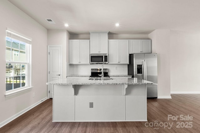 1204 May Apple Dr, Matthews, NC 28104 - kitchen with stainless steel appliances, dark wood-type flooring, a center island with sink, tasteful backsplash, and recessed lighting