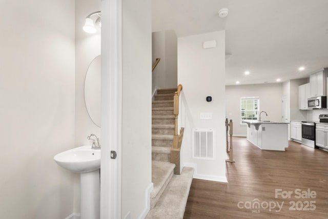 1204 May Apple Dr, Matthews, NC 28104 - stairs with wood finished floors and recessed lighting