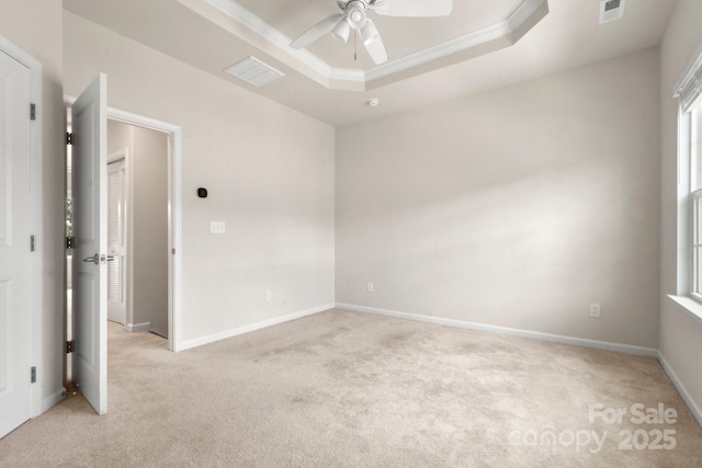 1204 May Apple Dr, Matthews, NC 28104 - empty room with light colored carpet, ceiling fan, a tray ceiling, ornamental molding, and healthy amount of natural light