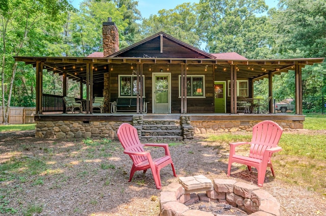 7 Bachelder Ln, Candler, NC 28715 - back of property featuring an outdoor fire pit, a chimney, and a patio area