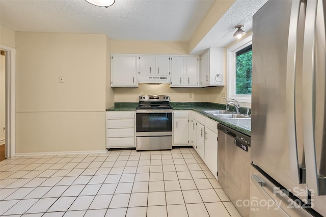 18 Golden Oaks Ln, Fletcher, NC 28732 - kitchen featuring appliances with stainless steel finishes, dark countertops, a textured ceiling, white cabinetry, and under cabinet range hood
