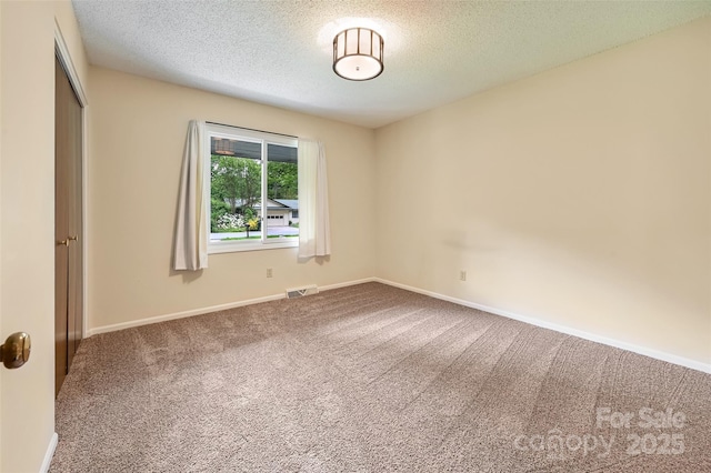 18 Golden Oaks Ln, Fletcher, NC 28732 - unfurnished bedroom featuring carpet flooring, a closet, and a textured ceiling