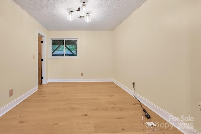 18 Golden Oaks Ln, Fletcher, NC 28732 - empty room featuring a textured ceiling and light wood-style flooring