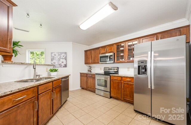 4068 Sherri Ln, Fort Mill, SC 29715 - kitchen featuring appliances with stainless steel finishes, ornamental molding, glass insert cabinets, light tile patterned floors, and brown cabinetry