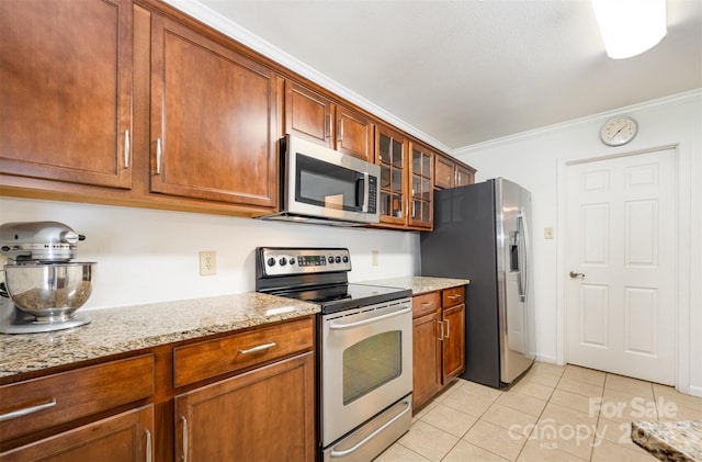4068 Sherri Ln, Fort Mill, SC 29715 - kitchen with stainless steel appliances, light tile patterned flooring, ornamental molding, brown cabinets, and glass insert cabinets