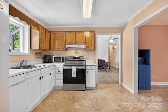 5445 Creekwood Dr, Salisbury, NC 28147 - kitchen with appliances with stainless steel finishes, under cabinet range hood, light countertops, ornamental molding, and white cabinetry