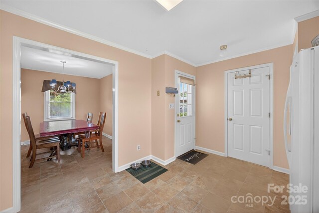 5445 Creekwood Dr, Salisbury, NC 28147 - foyer entrance featuring a chandelier, plenty of natural light, crown molding, and light stone finish floors