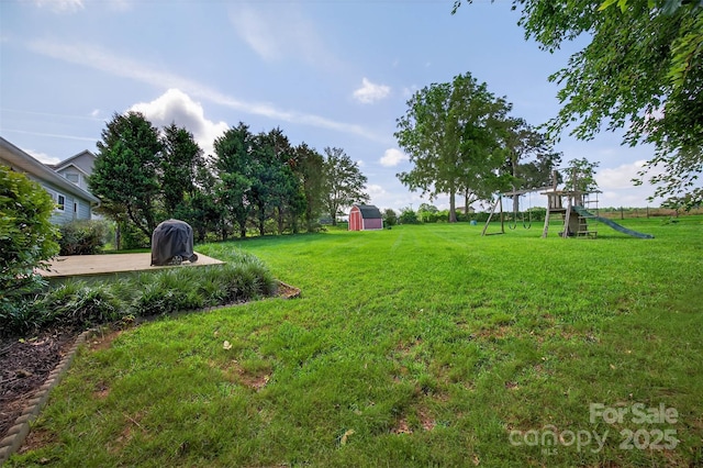 5445 Creekwood Dr, Salisbury, NC 28147 - view of green lawn featuring a playground and a shed