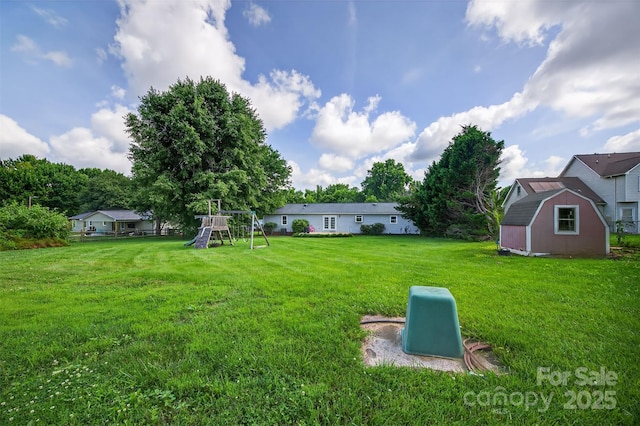 5445 Creekwood Dr, Salisbury, NC 28147 - view of grassy yard with a storage unit and a playground