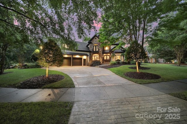 8016 Pemswood St, Charlotte, NC 28277 - view of front facade featuring stone siding, a lawn, concrete driveway, and a garage