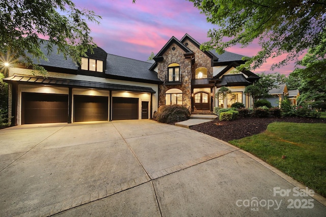 8016 Pemswood St, Charlotte, NC 28277 - french country style house with a standing seam roof, stone siding, driveway, a metal roof, and roof with shingles