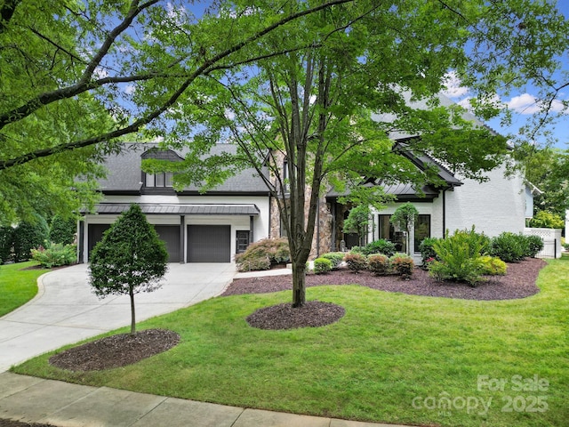 8016 Pemswood St, Charlotte, NC 28277 - view of front of property featuring a standing seam roof, driveway, a front lawn, a garage, and a metal roof