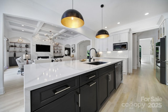 8016 Pemswood St, Charlotte, NC 28277 - kitchen featuring stainless steel appliances, white cabinetry, arched walkways, coffered ceiling, and dark cabinetry