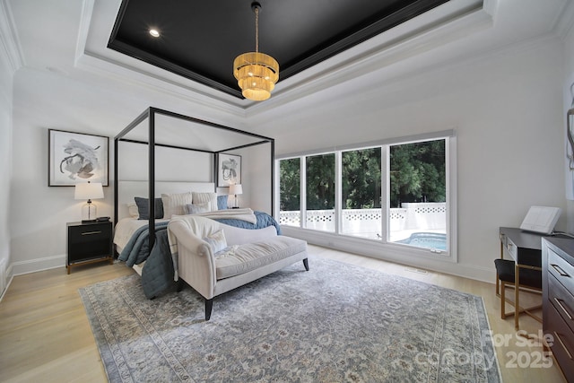 8016 Pemswood St, Charlotte, NC 28277 - bedroom featuring a tray ceiling, crown molding, and light wood finished floors