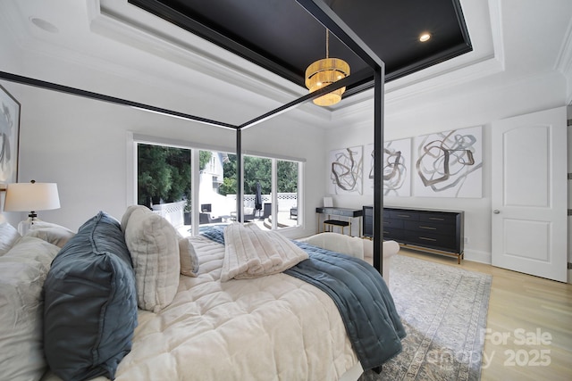 8016 Pemswood St, Charlotte, NC 28277 - bedroom featuring a raised ceiling, crown molding, and light wood-style flooring
