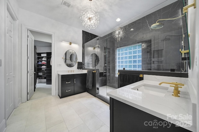 8016 Pemswood St, Charlotte, NC 28277 - bathroom with two vanities, a shower stall, and a walk in closet
