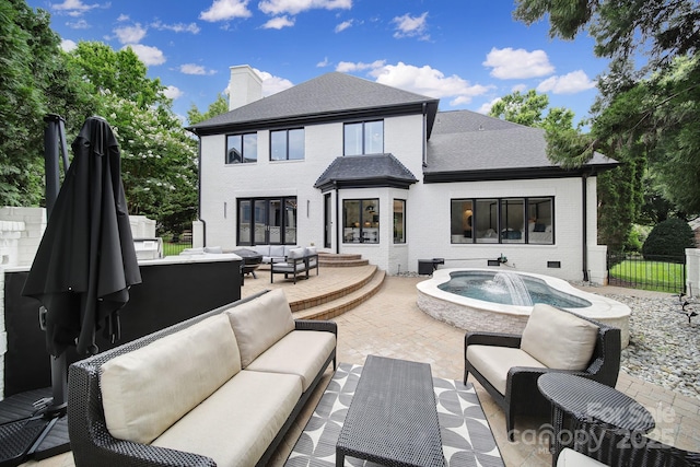 8016 Pemswood St, Charlotte, NC 28277 - rear view of house featuring outdoor lounge area, brick siding, a patio area, a chimney, and an outdoor hot tub