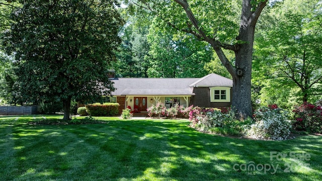 701 5th Ave NE, Conover, NC 28613 - view of front facade featuring french doors, a front yard, and brick siding