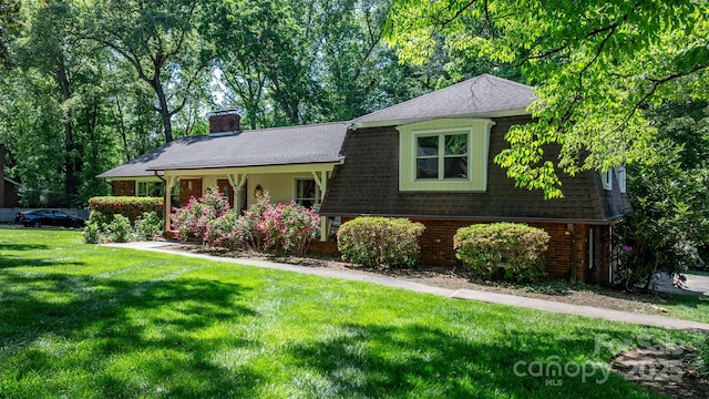701 5th Ave NE, Conover, NC 28613 - tri-level home with a front lawn, a chimney, a shingled roof, and brick siding