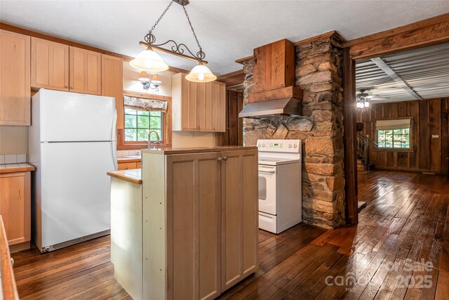 65 Woodfern Dr, Maggie Valley, NC 28751 - kitchen featuring white appliances, range hood, dark wood-style floors, a center island, and wooden walls